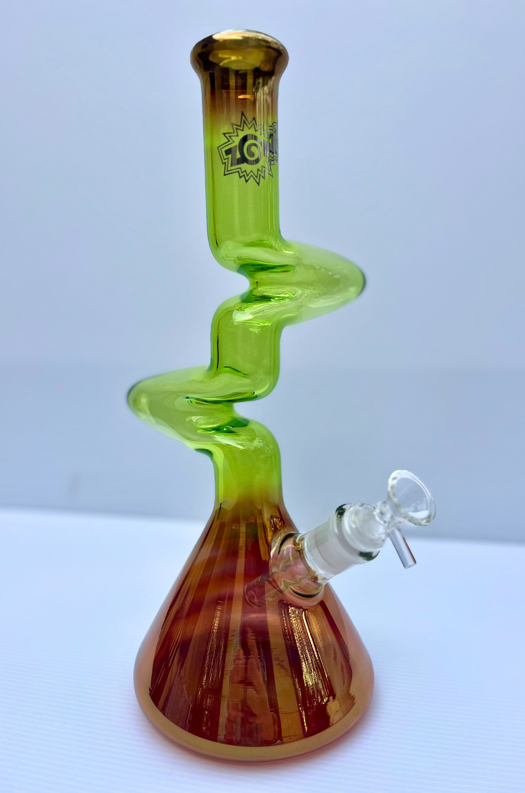 Glass smoking device with a spiral design in green and brown on a white background